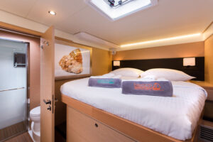 Luxury catamaran queen size bed, ensuite, luxurious, well-designed cabin with side access to bed, and complimentary towels.