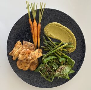 Lunch onboard a luxury catamaran, green pees puree, pan seared young carrots, grilled asparagus, baby spinach salad with toasted almonds and organic grilled chicken