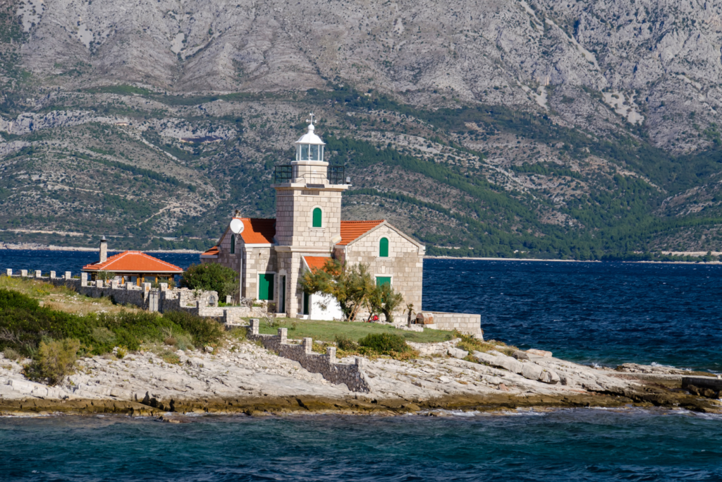 View from the last described of 5 charming towns on the Hvar island, from Sućuraj. The view is of Sućuraj lighthouse surrounded by the sea with mountains in the background